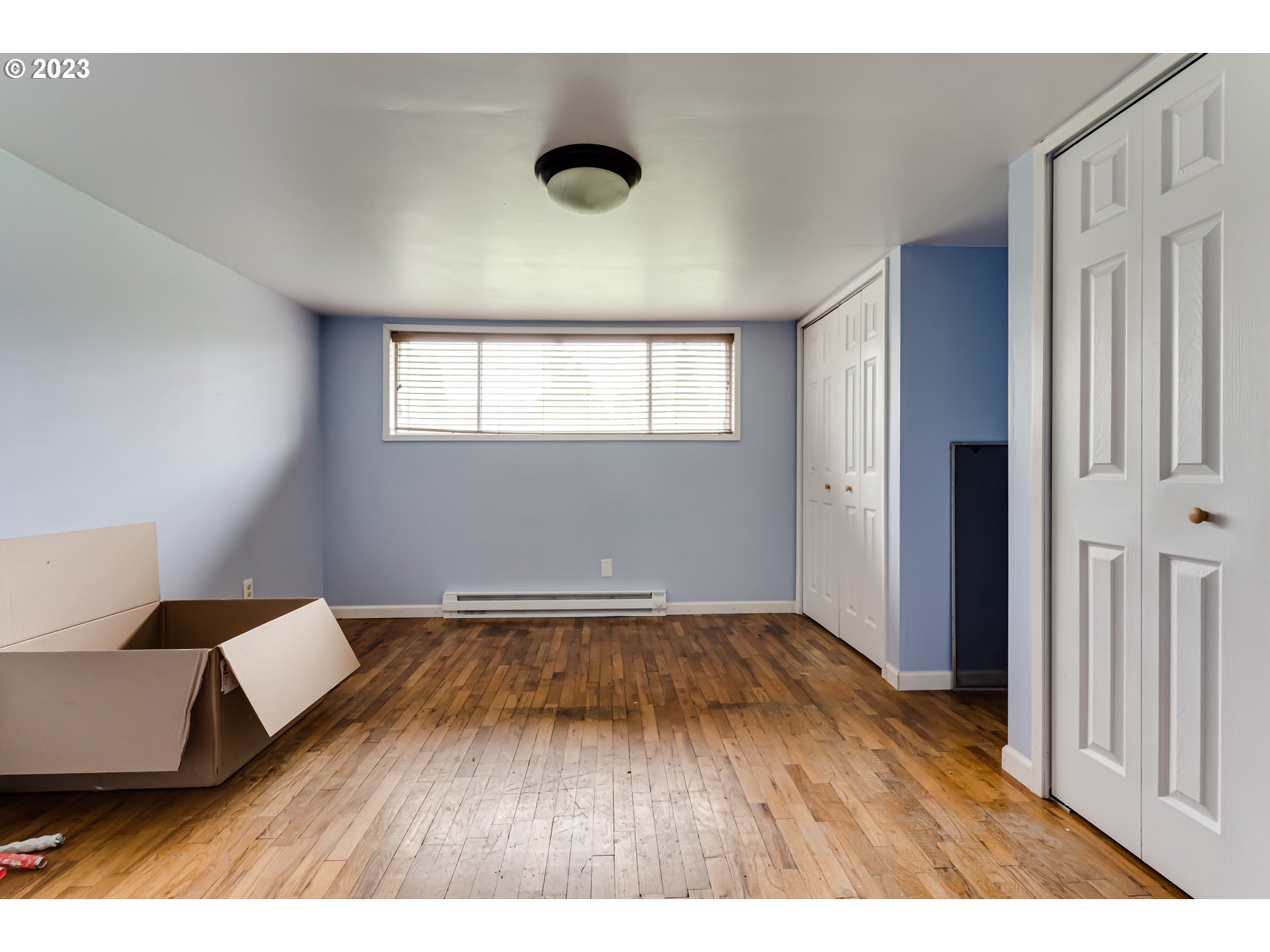 1163 D Street Springfield, OR 97477 - Photo 20 of 37 a view of an empty room with wooden floor and a window