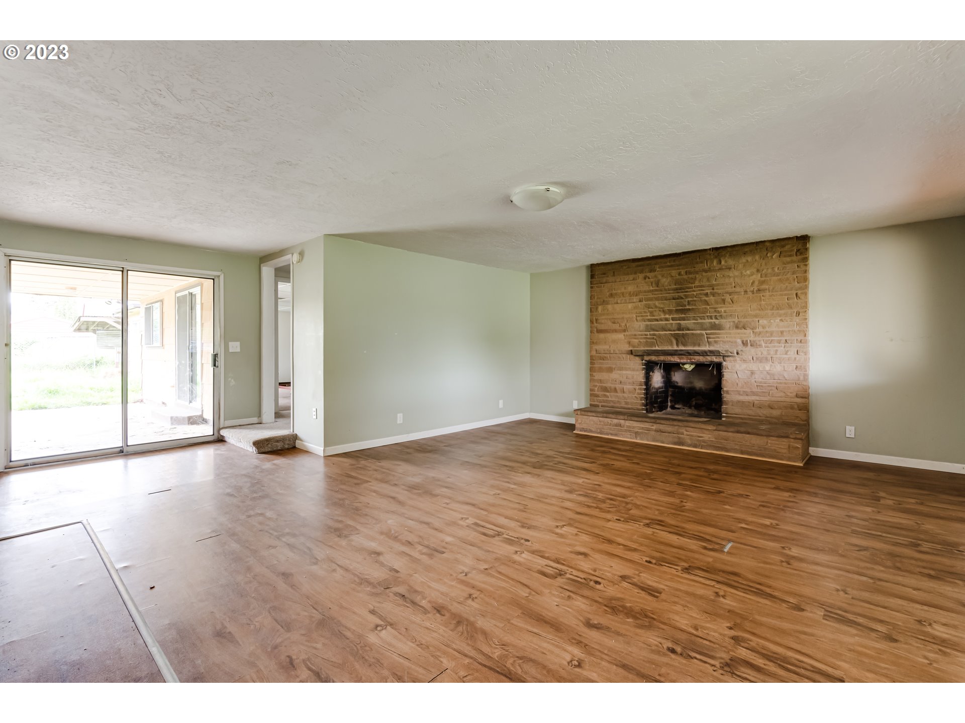 1163 D Street Springfield, OR 97477 - Photo 5 of 37 a view of empty room with wooden floor and fan