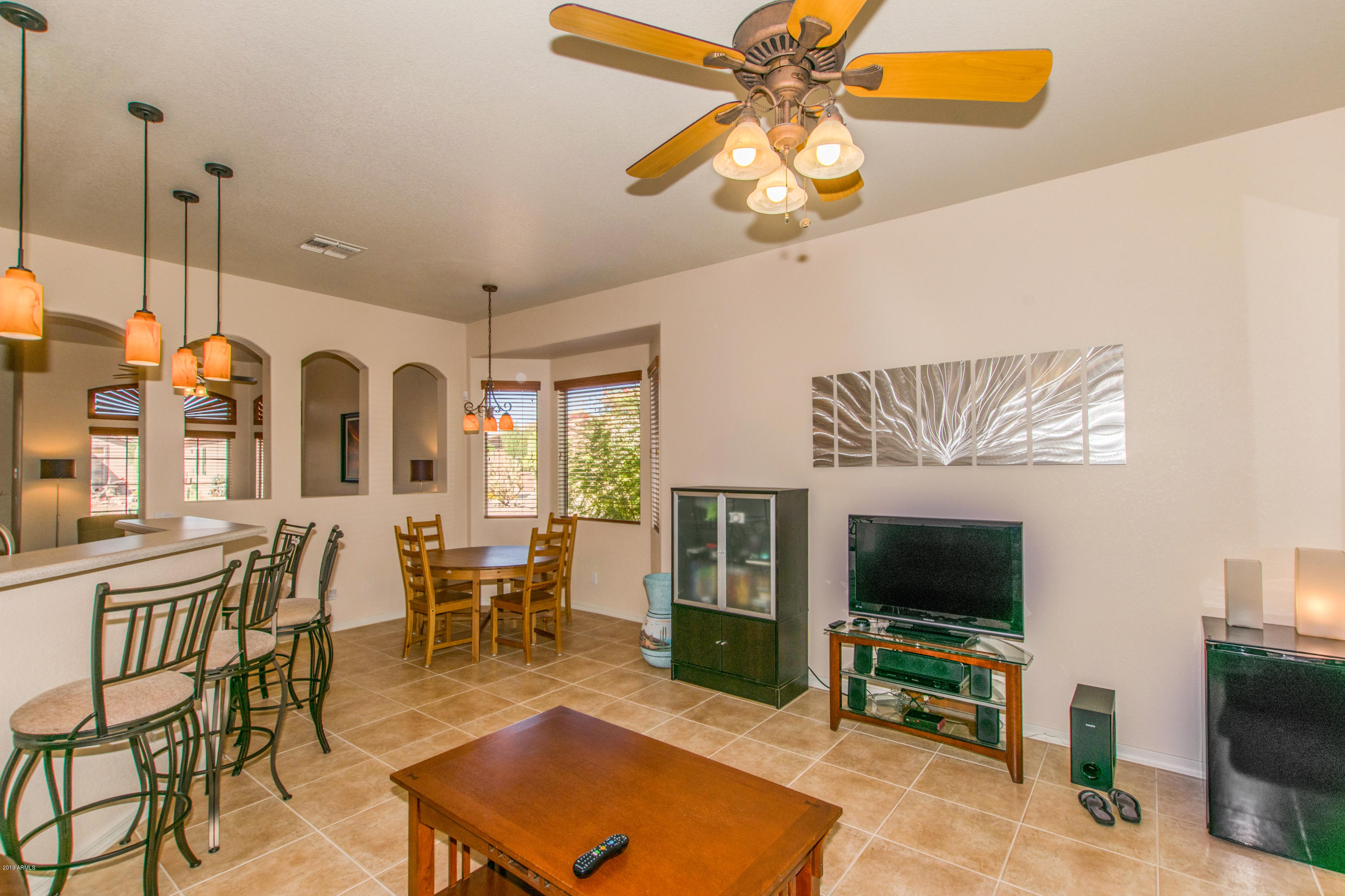 4291 South Strong Box Road Gold Canyon, AZ 85118 - Photo 11 of 27 a living room with furniture a flat screen tv and kitchen view