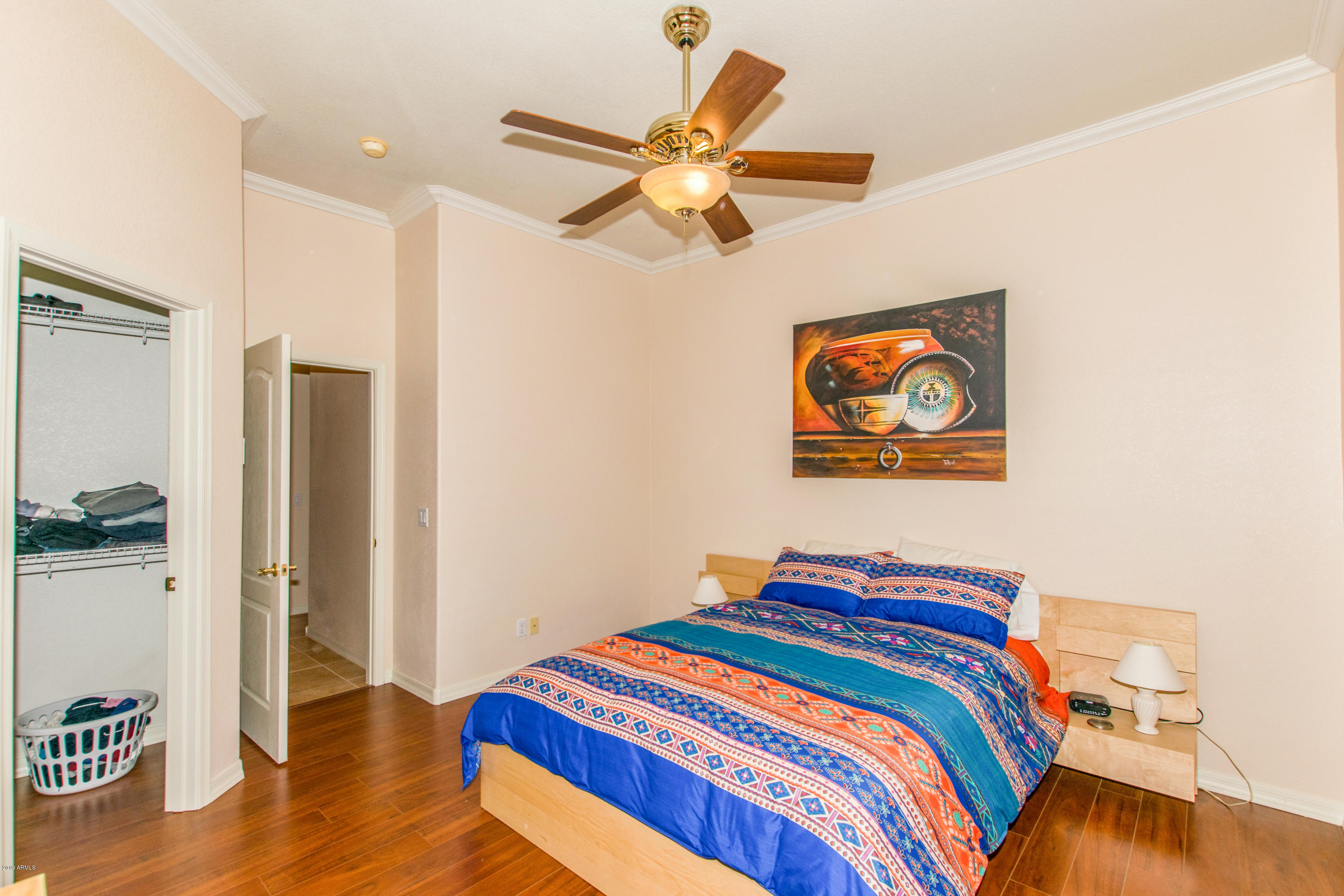 4291 South Strong Box Road Gold Canyon, AZ 85118 - Photo 15 of 27 a bedroom with bed and a chandelier