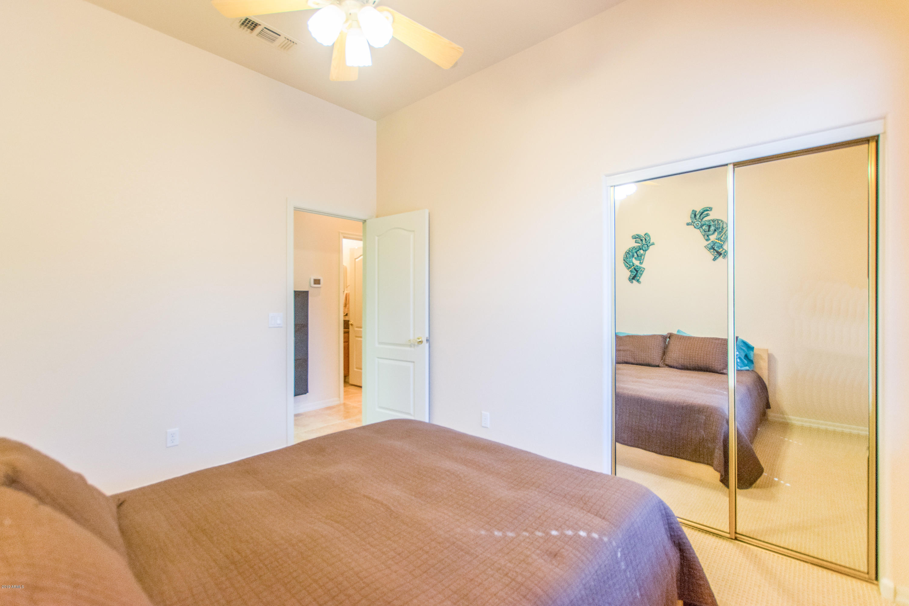4291 South Strong Box Road Gold Canyon, AZ 85118 - Photo 20 of 27 a bedroom with a bed and a painting on the wall