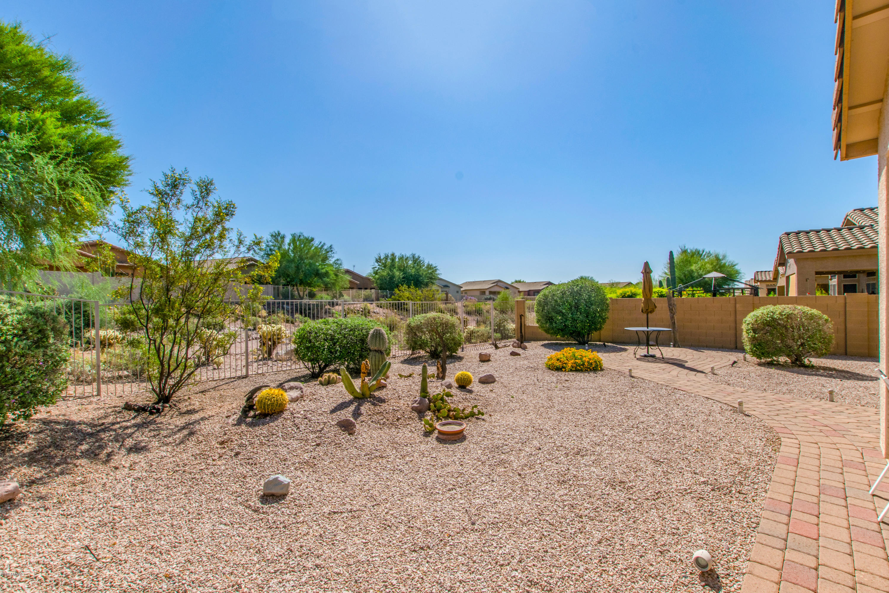 4291 South Strong Box Road Gold Canyon, AZ 85118 - Photo 22 of 27 a view of a backyard with a table and chairs