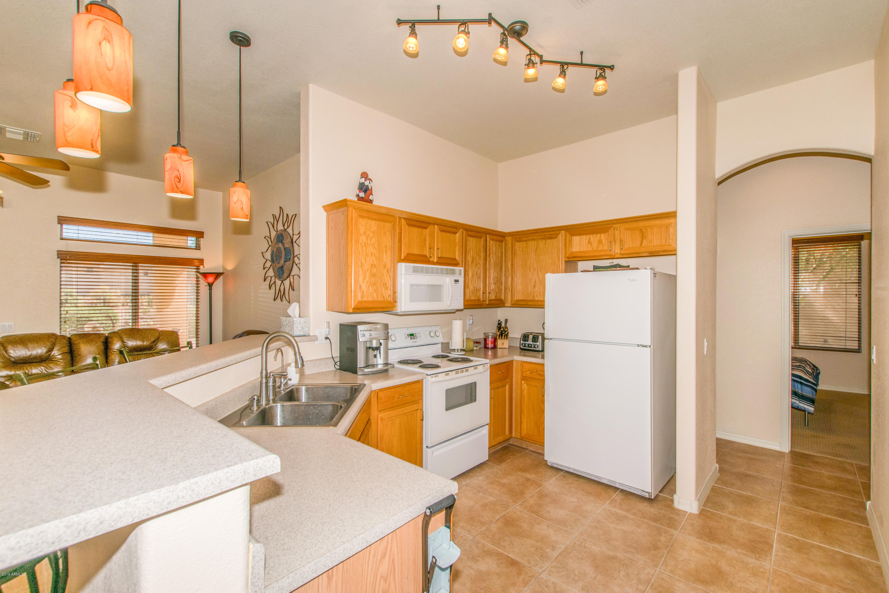 4291 South Strong Box Road Gold Canyon, AZ 85118 - Photo 6 of 27 a kitchen that has a refrigerator a stove a sink dishwasher with a dining table and chairs