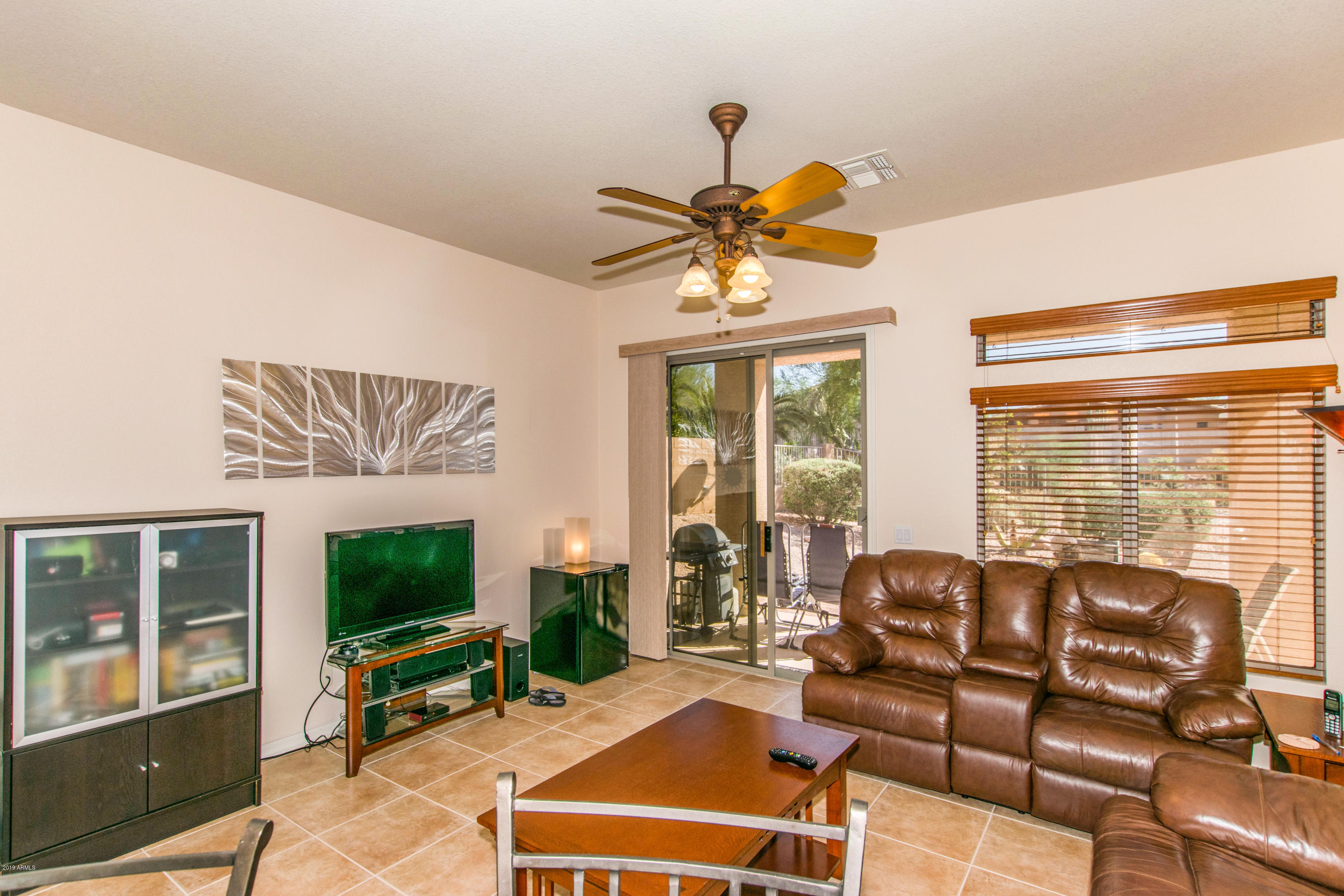 4291 South Strong Box Road Gold Canyon, AZ 85118 - Photo 9 of 27 a living room with furniture a flat screen tv and a large window