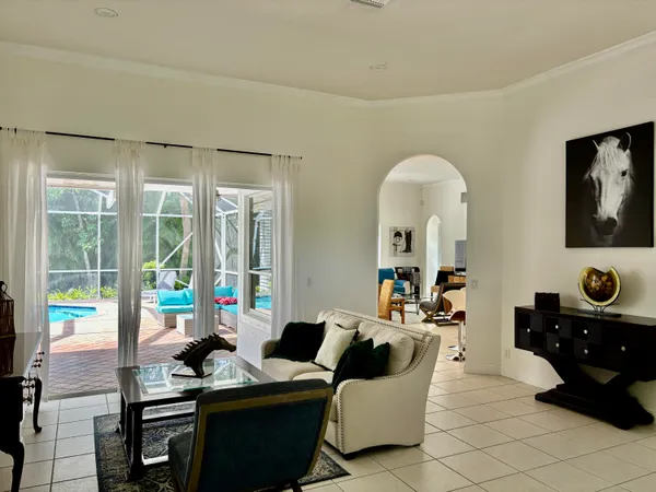 a living room with furniture and large windows