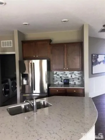 a view of a kitchen with a sink and a window