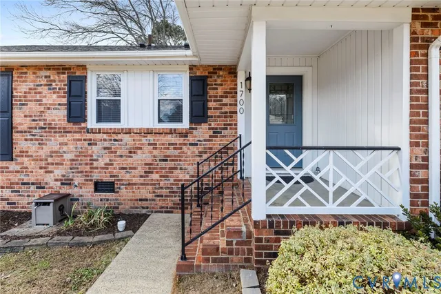 a front view of a house with a wall