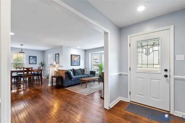 a living room with furniture wooden floor and a window