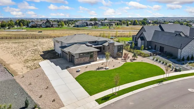 an aerial view of a house with outdoor space and lake view in back
