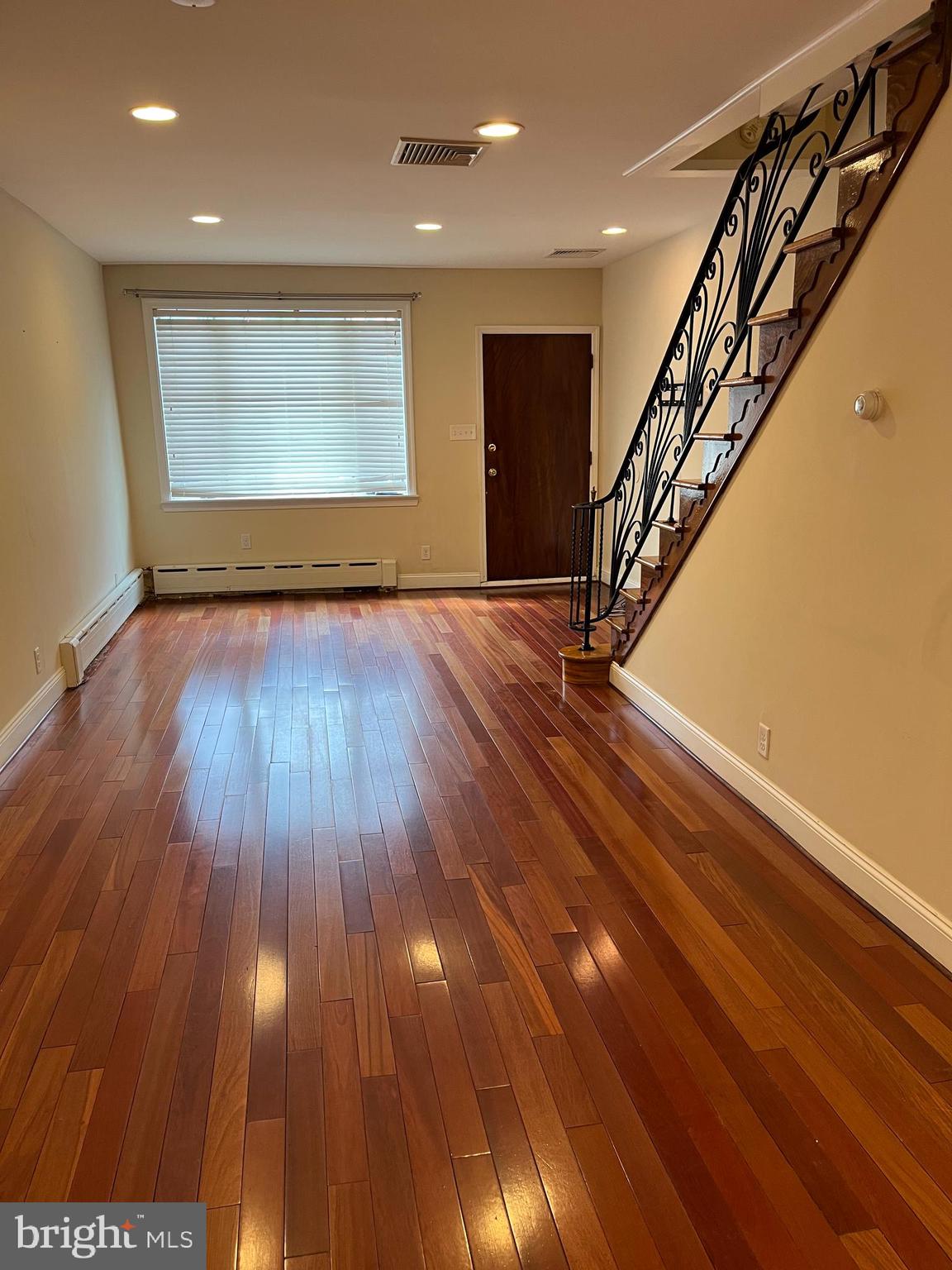 an entryway in a hall with wooden floor
