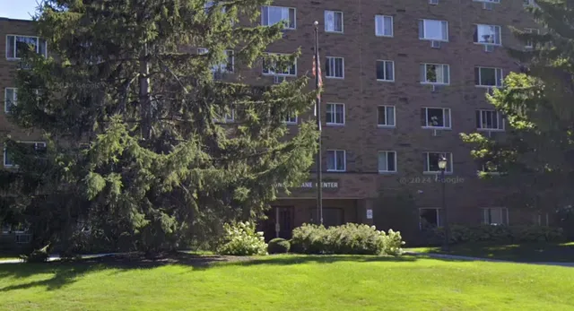 a brick building with a yard