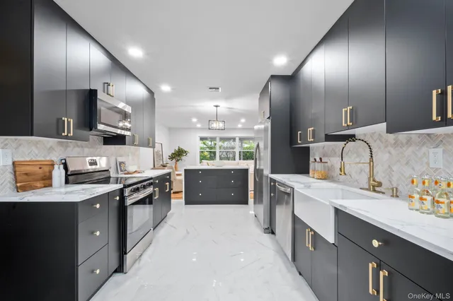 a large kitchen with stainless steel appliances lots of counter top space