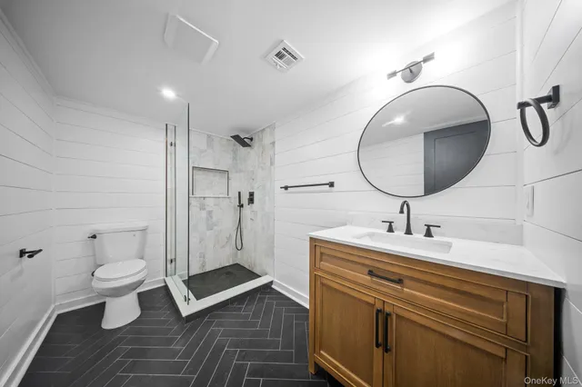 a bathroom with a sink mirror toilet and shower