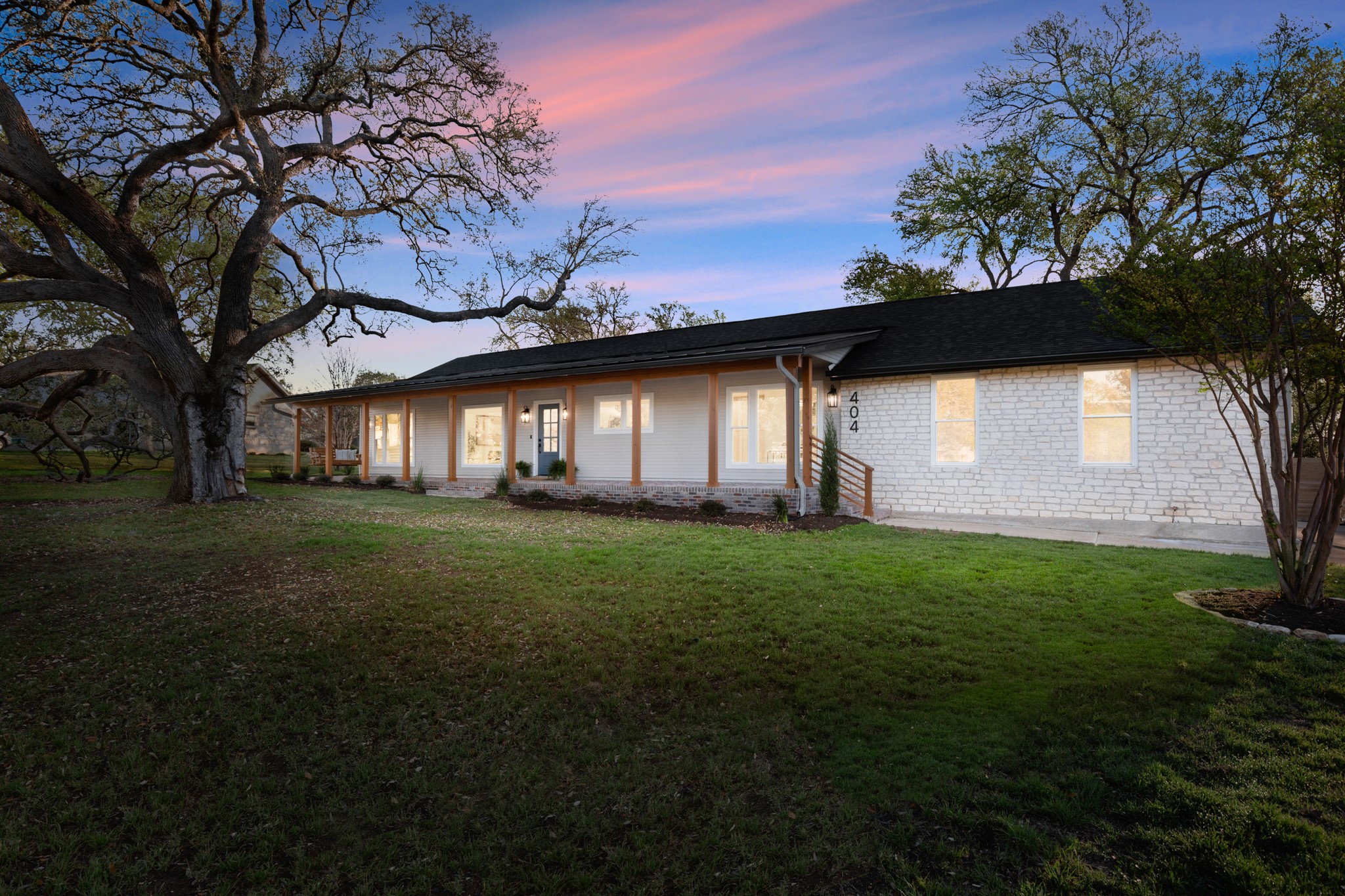 404 Bittern Drive Buda, TX 78610 - Photo 3 of 34 a front view of a house with a garden