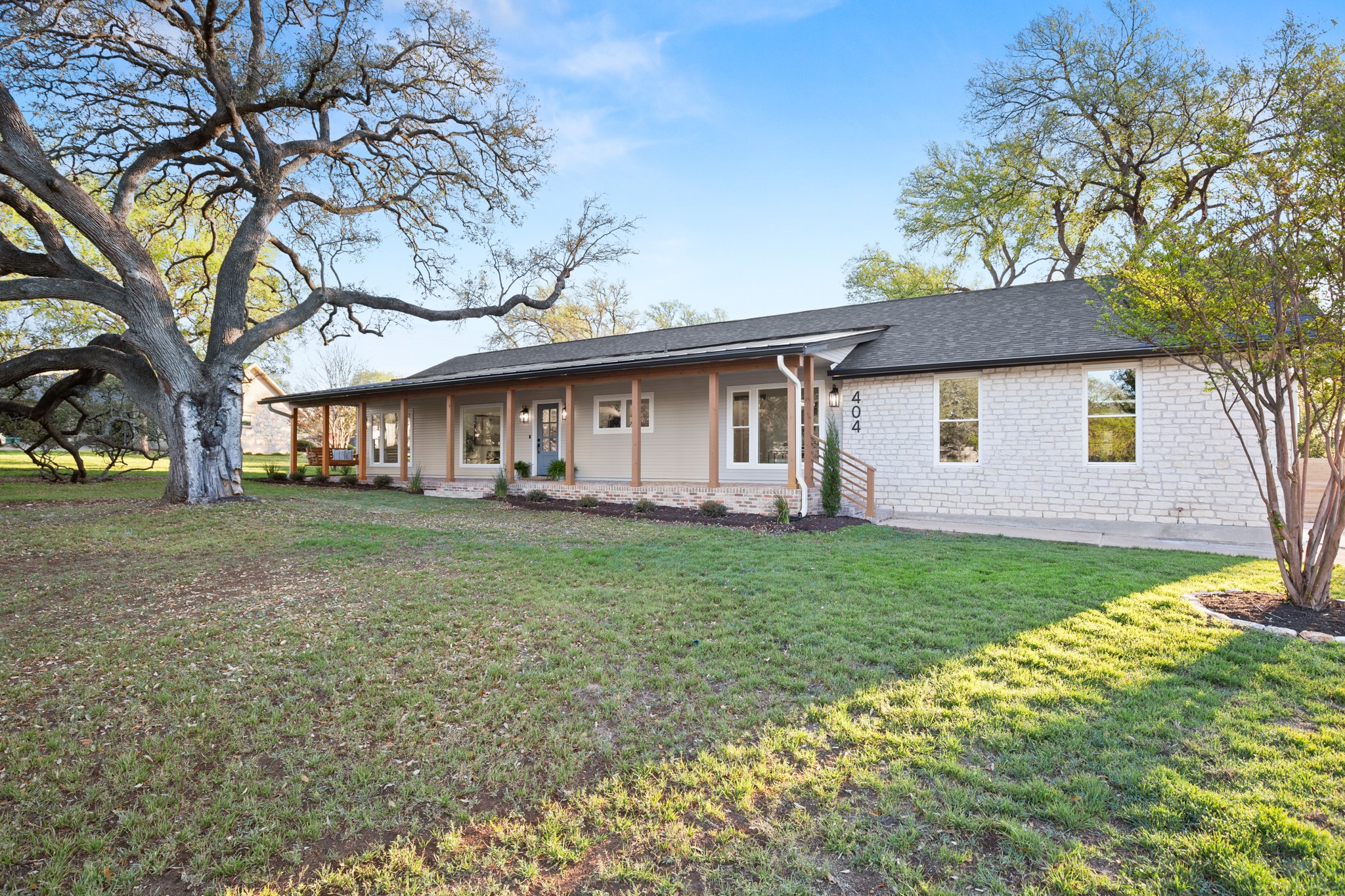 404 Bittern Drive Buda, TX 78610 - Photo 4 of 34 a view of a yard with a house and a large tree