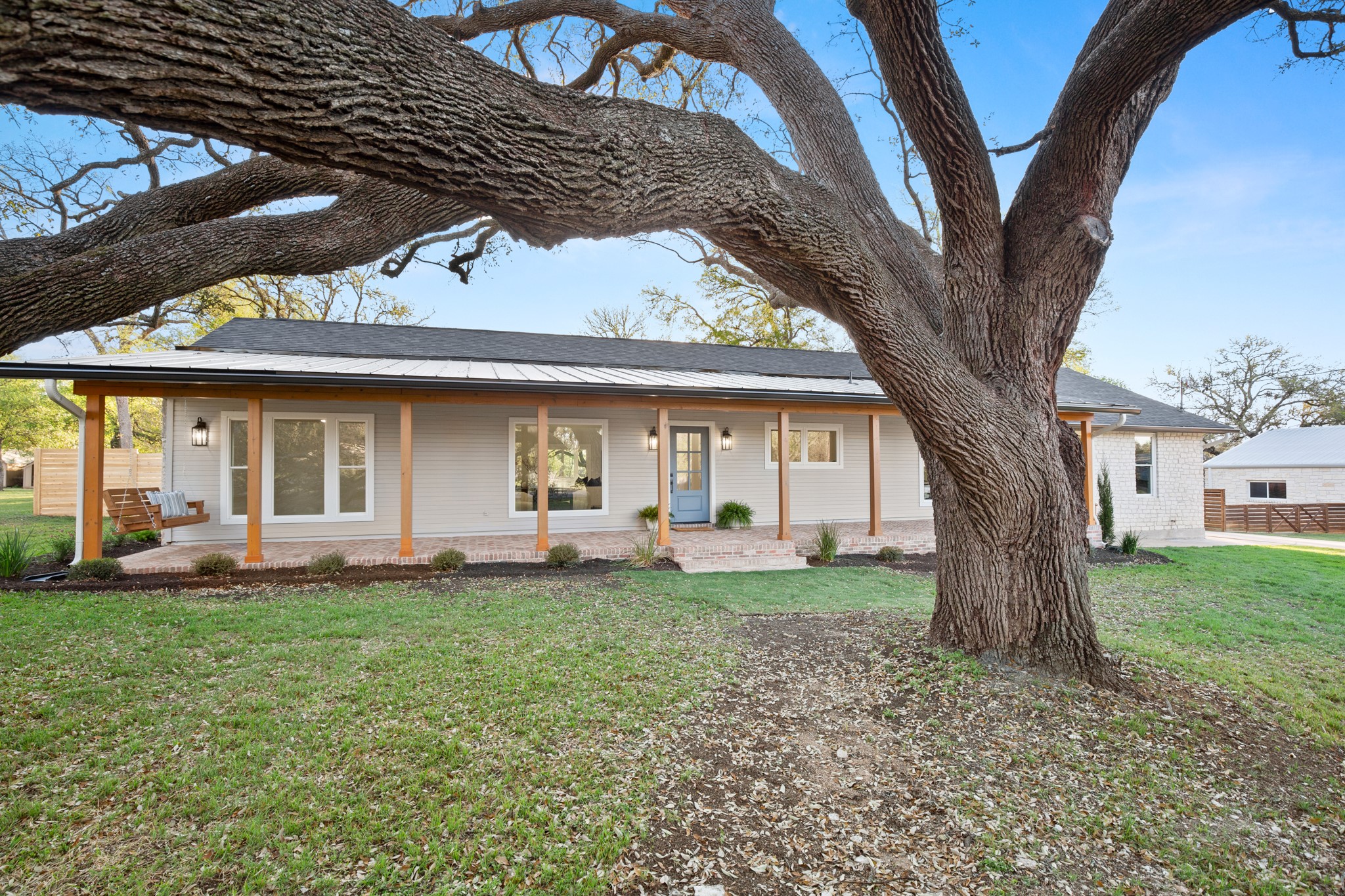 404 Bittern Drive Buda, TX 78610 - Photo 6 of 34 a front view of a house with a garden and trees