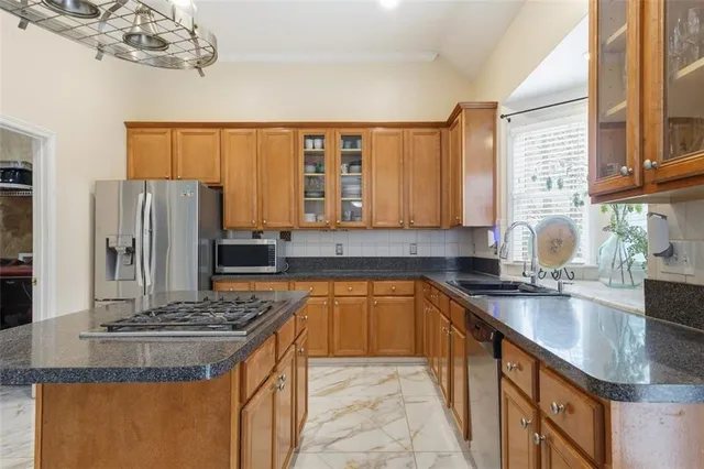 a kitchen with stainless steel appliances granite countertop a stove and a refrigerator