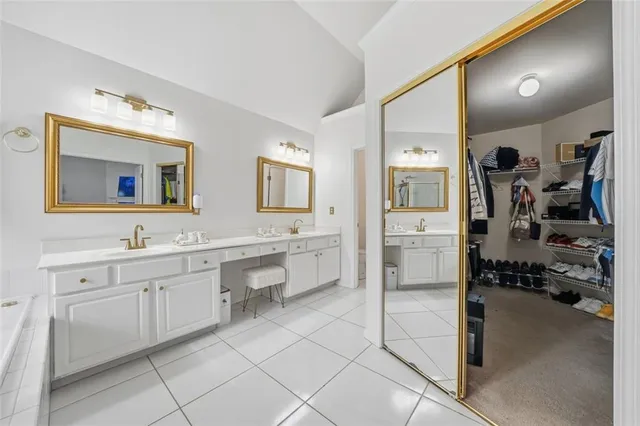 a bedroom with furniture and a large window