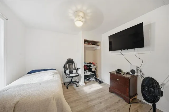a view of a brick house with windows and wooden fence