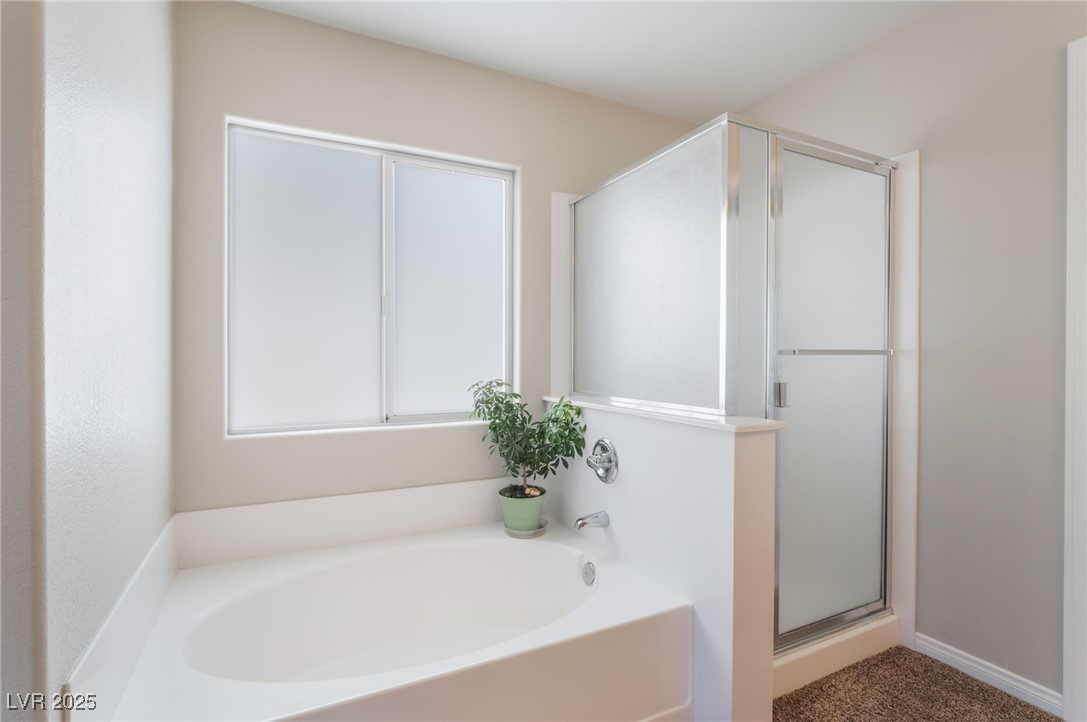 7857 Midnight Ride Street Las Vegas, NV 89131 - Photo 21 of 53 Bathroom with a bath and a shower stall
