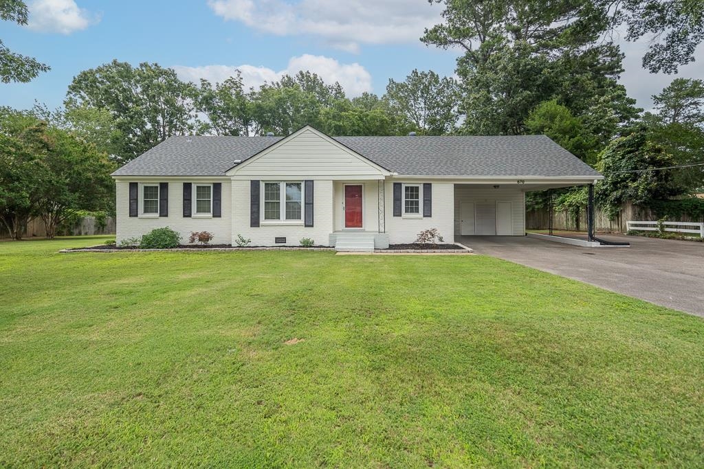 670 Peterson Lake Road Collierville, TN 38017 - Photo 1 of 37 White brick exterior with a dark shingle roof and a red front door