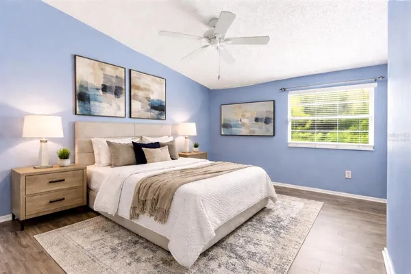 a bedroom with a large bed and a chandelier