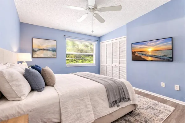 a bedroom with a bed and a flat screen tv