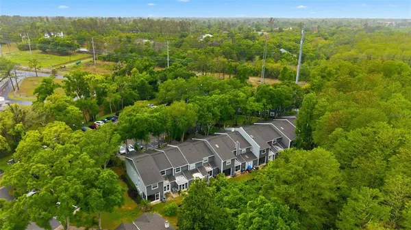 an aerial view of a house with a yard