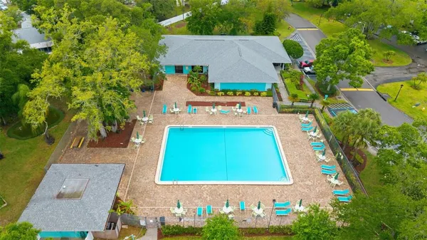 an aerial view of a house with a swimming pool a yard and a yard