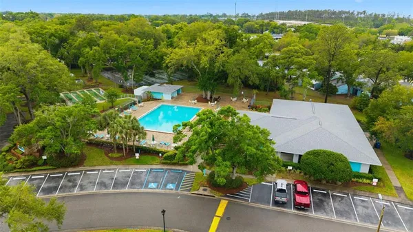 an aerial view of a house with a yard basket ball court and outdoor seating