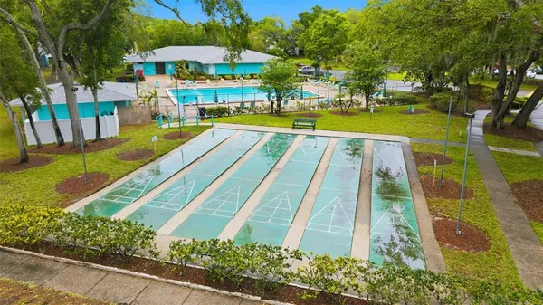 a view of swimming pool with outdoor seating and trees