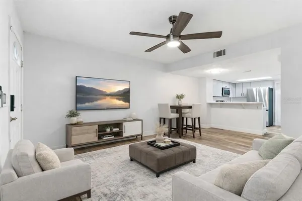 a living room with furniture and a flat screen tv