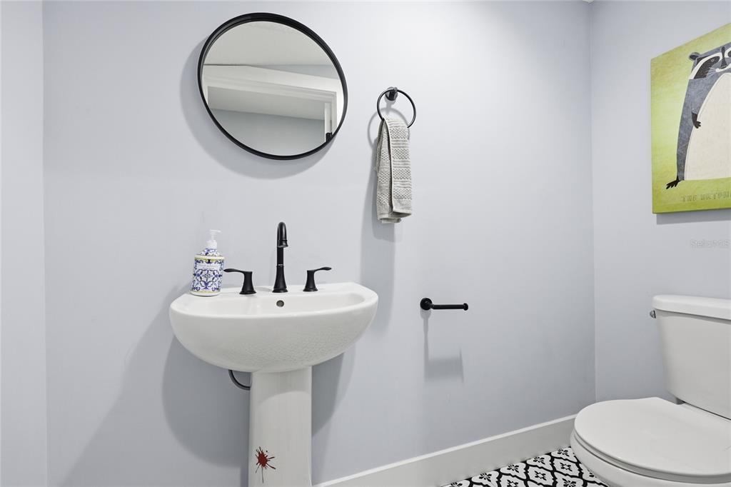 403 Northeast 9th Street Gainesville, FL 32601 - Photo 22 of 62 a bathroom with a sink a mirror and a toilet
