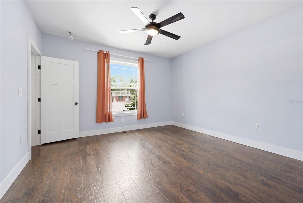 403 Northeast 9th Street Gainesville, FL 32601 - Photo 24 of 62 a view of an empty room with window and wooden floor