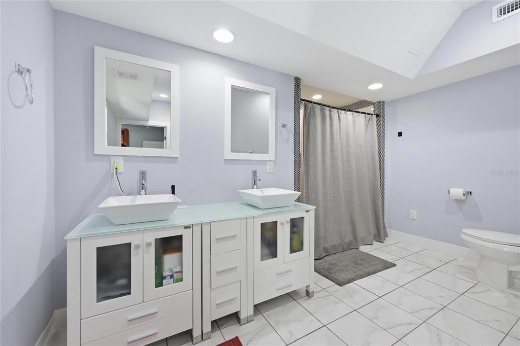 403 Northeast 9th Street Gainesville, FL 32601 - Photo 28 of 62 a spacious bathroom with a sink a toilet and shower