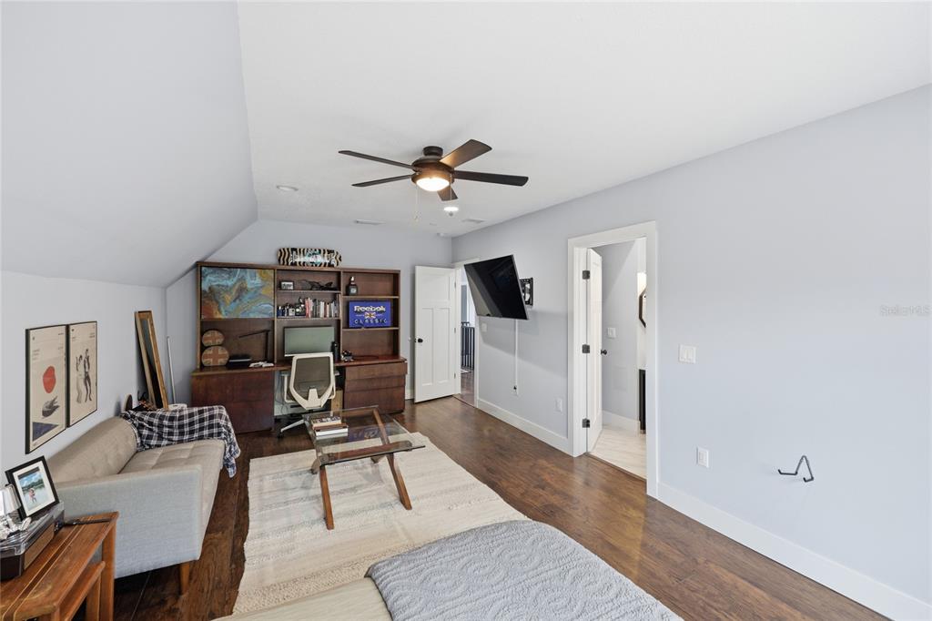 403 Northeast 9th Street Gainesville, FL 32601 - Photo 36 of 62 a living room with furniture a ceiling fan and a rug