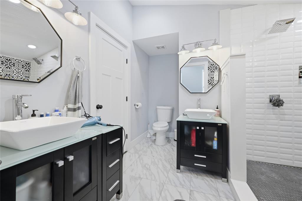 403 Northeast 9th Street Gainesville, FL 32601 - Photo 40 of 62 a bathroom with a sink vanity and a mirror