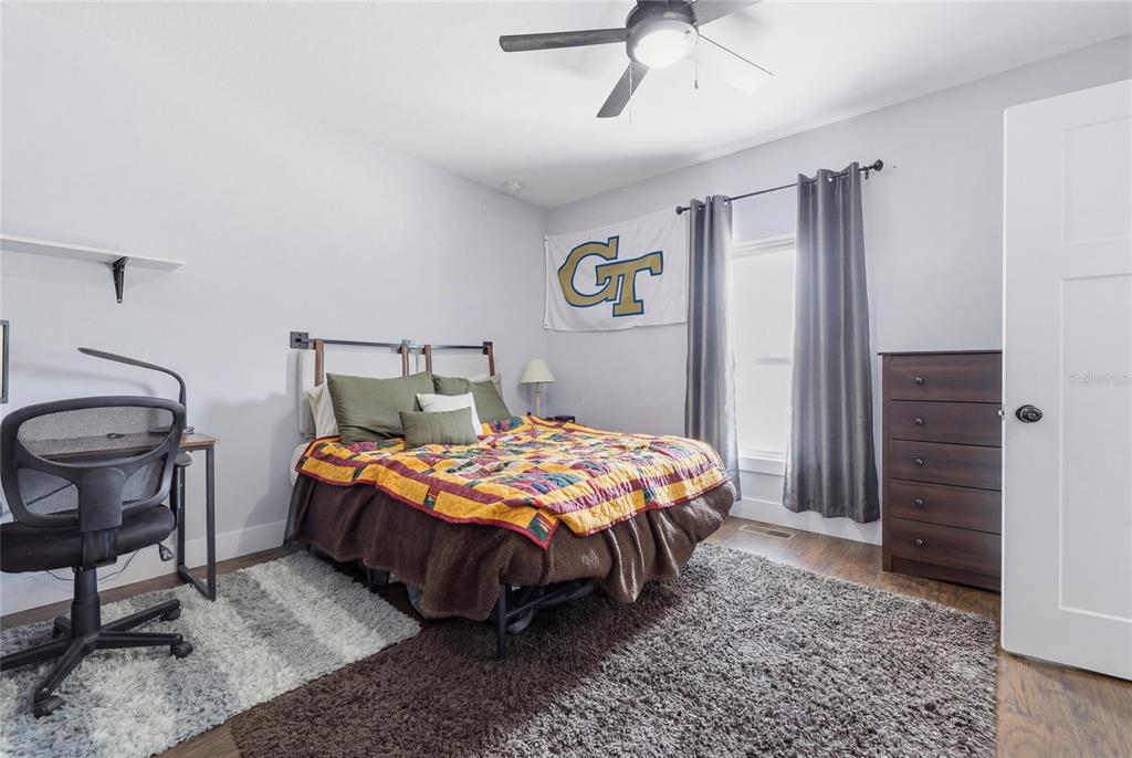 403 Northeast 9th Street Gainesville, FL 32601 - Photo 49 of 62 a bedroom with a bed a table and chair