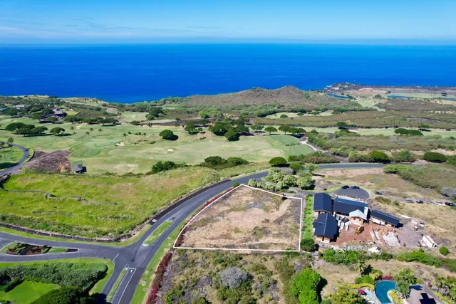 an aerial view of a houses with a yard