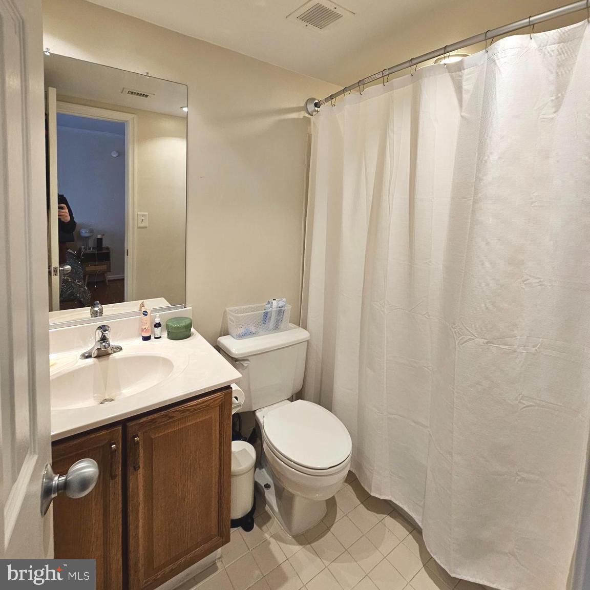 505 East Braddock Road, Unit 608 Alexandria, VA 22314 - Photo 13 of 15 a bathroom with a sink a toilet and shower curtain