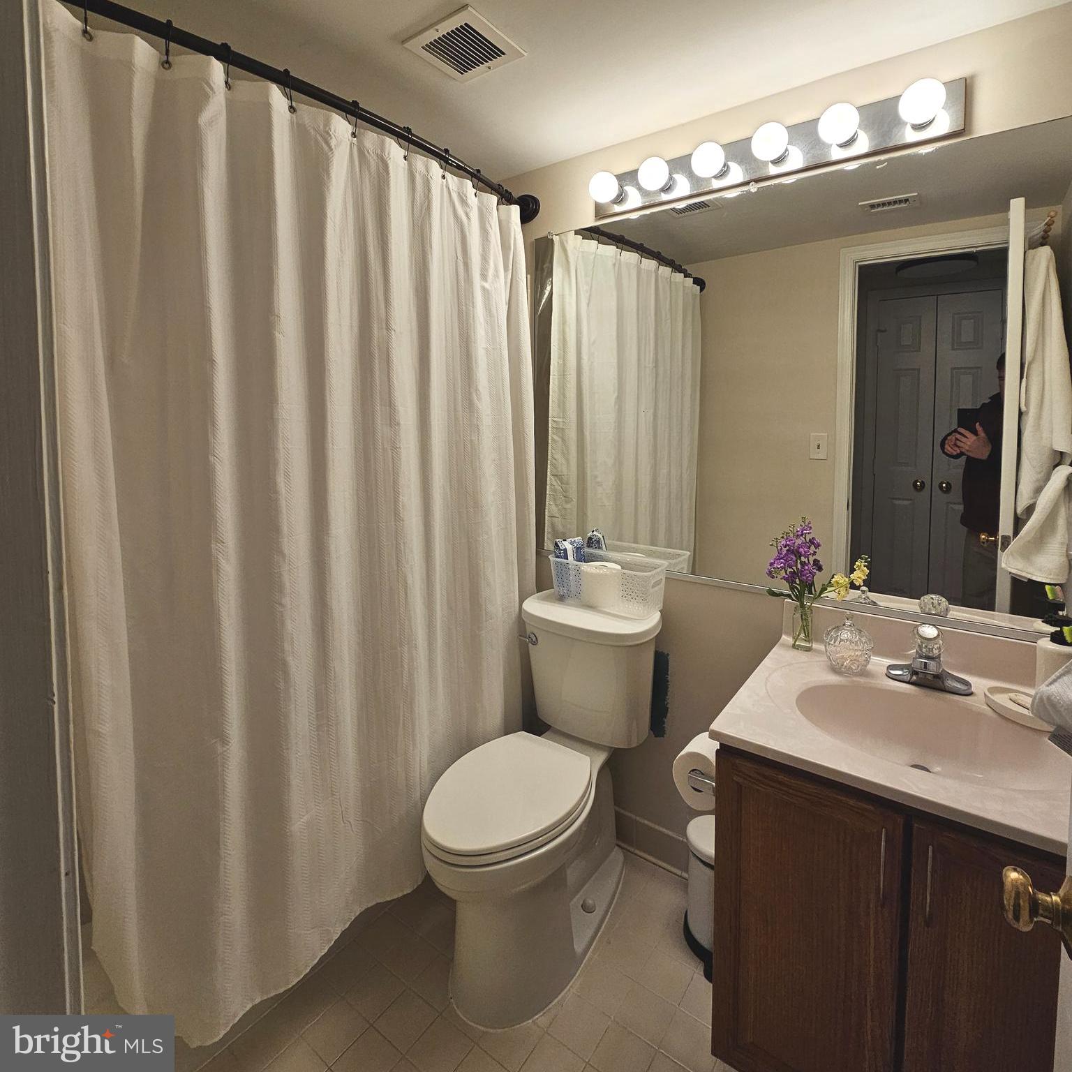 505 East Braddock Road, Unit 608 Alexandria, VA 22314 - Photo 15 of 15 a bathroom with a toilet a sink and a mirror