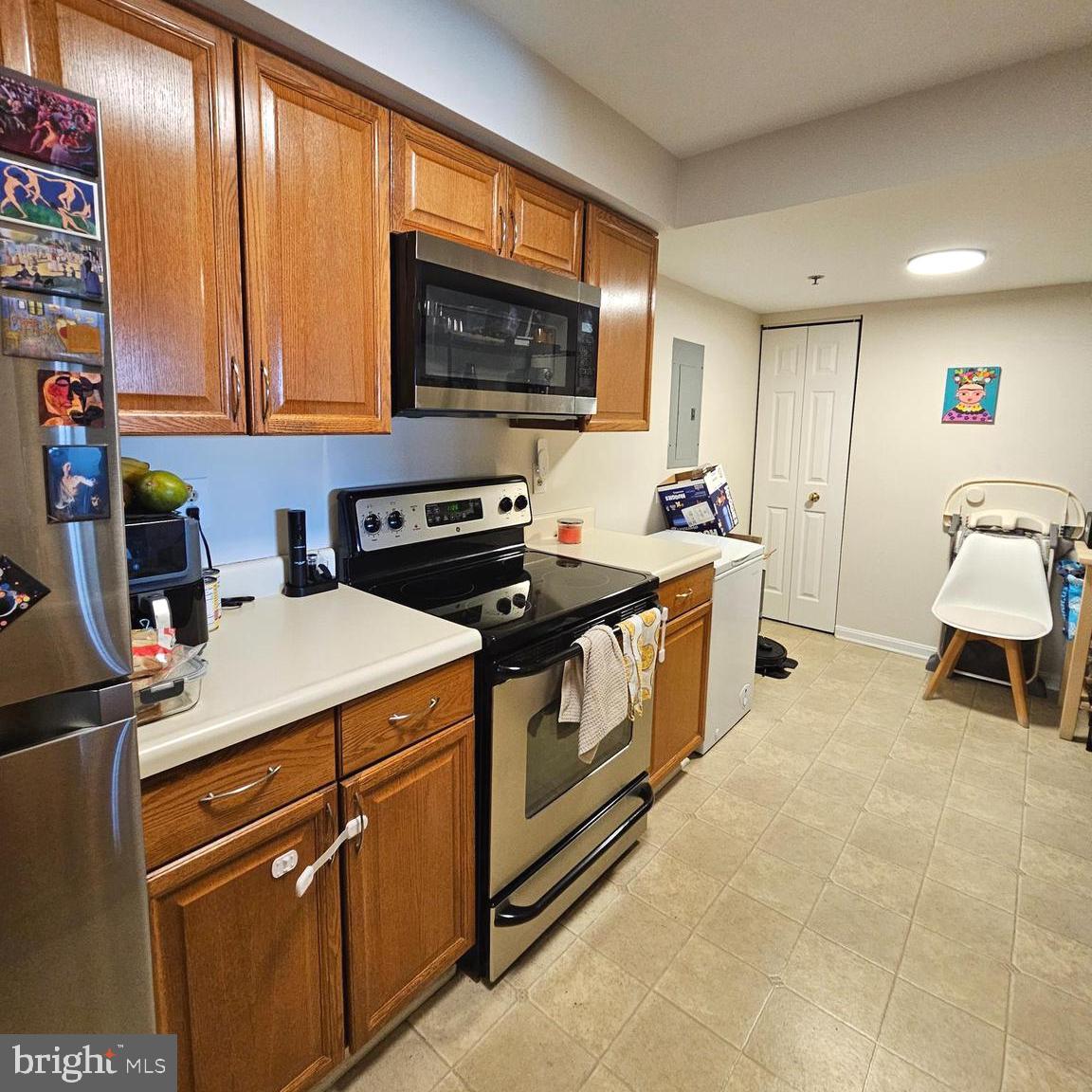 505 East Braddock Road, Unit 608 Alexandria, VA 22314 - Photo 8 of 15 a kitchen with a stove a sink and a microwave