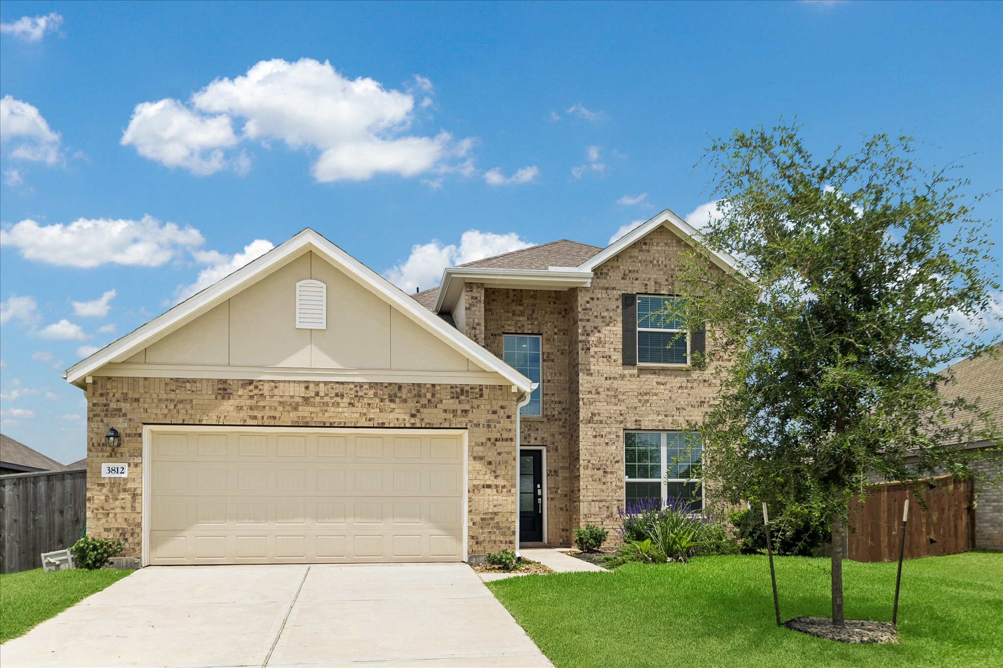 This is a charming two-story brick home featuring a double garage, a well-maintained front yard, and a welcoming entrance. Ideal for families seeking comfort and style.