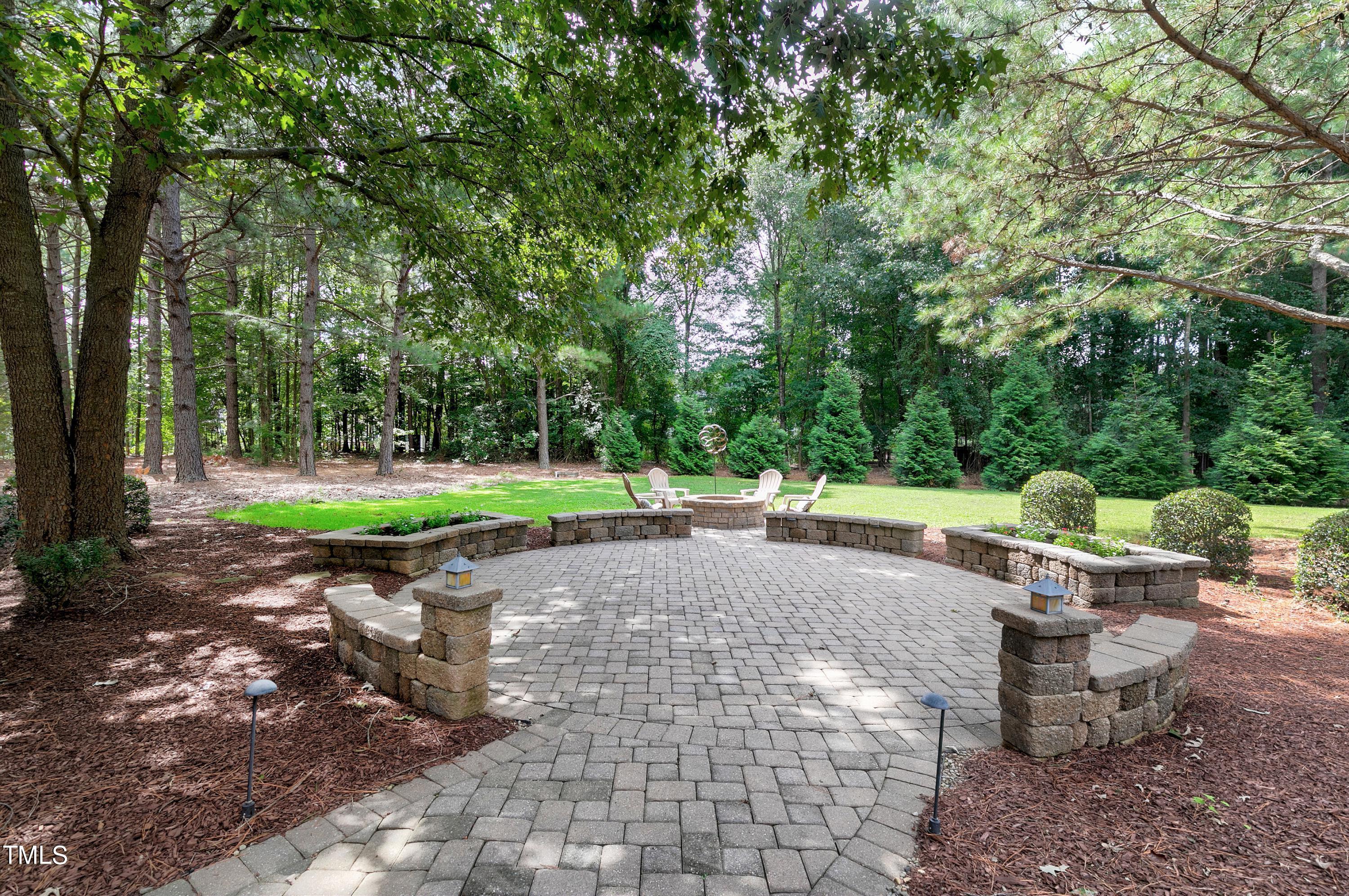 4729 Fielding Drive Raleigh, NC 27606 - Photo 44 of 50 22' circular patio with sitting wall and firepit is the perfect place for entertaining!