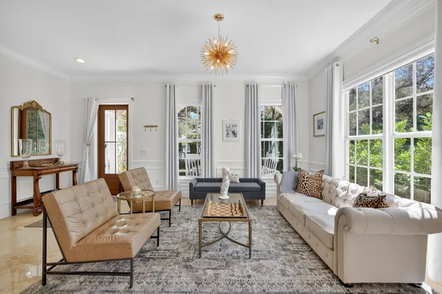 a living room with furniture and a dining table with kitchen view