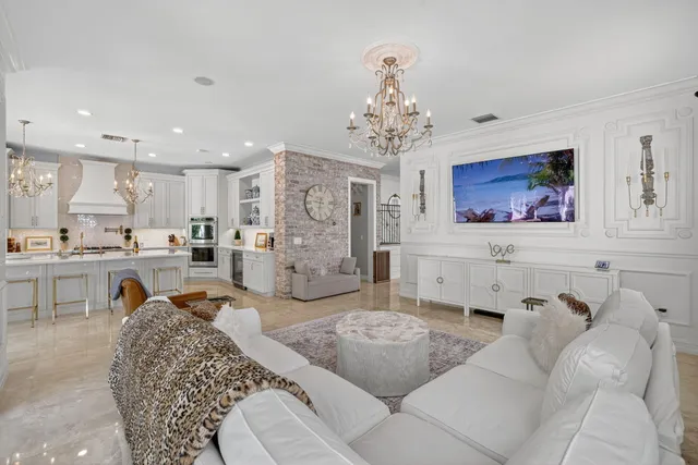 a kitchen with stainless steel appliances white cabinets and a potted plant