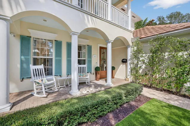 a front view of a house with yard and green space