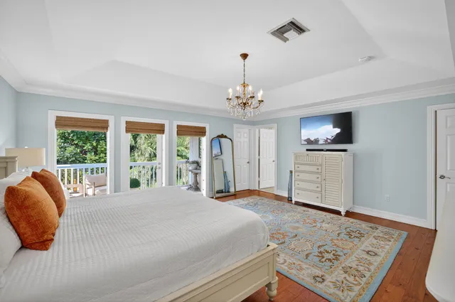 an aerial view of a house with a yard and lake view