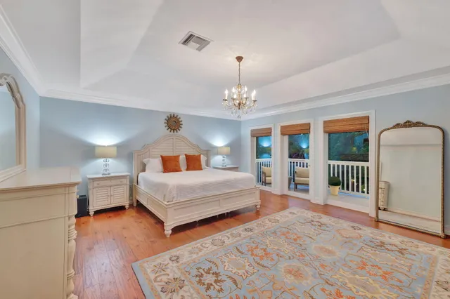 an aerial view of a house with a yard and lake view