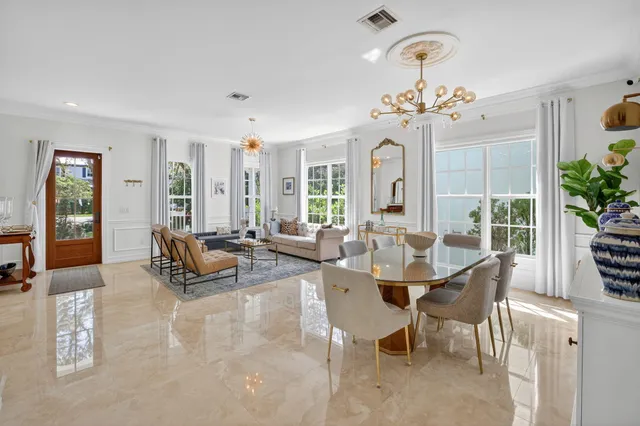a living room with furniture and a chandelier